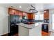 Bright kitchen with cherry cabinets, granite countertops, and stainless steel sink at 19043 E 58Th Ave, Denver, CO 80249