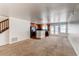 Spacious living room with an open layout that connects to the kitchen and dining area with carpet flooring at 19043 E 58Th Ave, Denver, CO 80249