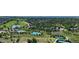 Aerial view of community featuring a pool, tennis courts, a golf course and lush green landscaping at 9232 Bauer Ct, Lone Tree, CO 80124