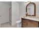 Stylish bathroom featuring modern vanity, decorative mirror, and tiled shower at 9232 Bauer Ct, Lone Tree, CO 80124