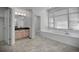 Bright bathroom featuring a soaking tub, double vanity, and tile floors at 9232 Bauer Ct, Lone Tree, CO 80124