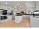 Remodeled kitchen with granite counters, stainless appliances, and a kitchen island at 9232 Bauer Ct, Lone Tree, CO 80124