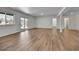 Spacious living room features hardwood flooring, large windows, and natural light throughout the space at 9232 Bauer Ct, Lone Tree, CO 80124