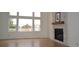 Sunlit living room featuring hardwood floors and a stone fireplace at 9232 Bauer Ct, Lone Tree, CO 80124