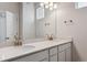Elegant bathroom with a double sink vanity, featuring quartz countertops and modern fixtures at 457 Interlocken Blvd # 106, Broomfield, CO 80021