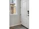 Bright entryway featuring a white front door, wood floors and a window at 457 Interlocken Blvd # 106, Broomfield, CO 80021