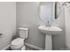 Bathroom featuring a pedestal sink, toilet and grey paint at 457 Interlocken Blvd # 106, Broomfield, CO 80021