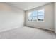 Bedroom featuring a large window, neutral walls, and carpet flooring at 457 Interlocken Blvd # 106, Broomfield, CO 80021