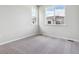 This bedroom features neutral paint and carpet at 457 Interlocken Blvd # 106, Broomfield, CO 80021