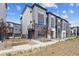 Modern townhome with brick accents and professional landscaping at 457 Interlocken Blvd # 106, Broomfield, CO 80021