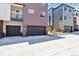View of the attached garages and landscaping at 457 Interlocken Blvd # 106, Broomfield, CO 80021