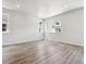 Spacious room with large windows, neutral walls, and grey wood-style flooring at 457 Interlocken Blvd # 106, Broomfield, CO 80021