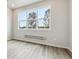 Spacious room with large windows, neutral walls, and grey wood-style flooring at 457 Interlocken Blvd # 106, Broomfield, CO 80021