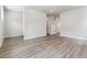 Spacious living room area featuring gray wood-style flooring and neutral paint at 457 Interlocken Blvd # 106, Broomfield, CO 80021