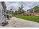 Spacious backyard with a stone patio, lush green lawn, privacy fence, and manicured landscaping at 9458 S Hackberry Ln, Highlands Ranch, CO 80129