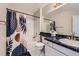 Well-maintained bathroom featuring a shower-tub combo, modern fixtures, and stylish decorative elements at 9458 S Hackberry Ln, Highlands Ranch, CO 80129