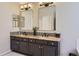 Modern bathroom featuring dual sinks, granite countertops, and stylish mirrors with vanity lighting at 9458 S Hackberry Ln, Highlands Ranch, CO 80129