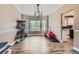 Bright dining area with hardwood floors, a modern chandelier, and a view of the backyard at 9458 S Hackberry Ln, Highlands Ranch, CO 80129