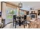 Bright dining area with sliding door access to the deck, and open to the cozy fireplace living room at 9458 S Hackberry Ln, Highlands Ranch, CO 80129