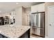 Stylish kitchen featuring granite countertops, stainless steel appliances, and ample cabinet space at 9458 S Hackberry Ln, Highlands Ranch, CO 80129