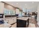 Modern kitchen with granite countertops, stainless steel appliances, and an open view to the living room at 9458 S Hackberry Ln, Highlands Ranch, CO 80129