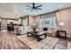 Open-concept living room flows into the kitchen, with ample seating and natural light at 9458 S Hackberry Ln, Highlands Ranch, CO 80129
