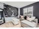 Cozy living room with a comfortable sectional sofa, a statement tapestry, and a bright window at 9458 S Hackberry Ln, Highlands Ranch, CO 80129