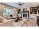 Inviting living room featuring a fireplace, built-in shelving, and a comfortable seating arrangement at 9458 S Hackberry Ln, Highlands Ranch, CO 80129