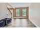 Spacious living room with hardwood floors, a staircase, and large windows for natural light at 9458 S Hackberry Ln, Highlands Ranch, CO 80129