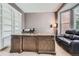 Comfortable office with built-in bookshelves, a large desk, and a cozy leather couch at 9458 S Hackberry Ln, Highlands Ranch, CO 80129