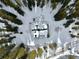 Aerial view of a snow covered cabin surrounded by a forest of trees at 812 High Point Dr, Breckenridge, CO 80424
