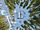 Aerial view of a snow covered cabin surrounded by a forest of trees at 812 High Point Dr, Breckenridge, CO 80424