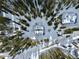 Aerial view of a snow covered cabin surrounded by a forest of trees at 812 High Point Dr, Breckenridge, CO 80424