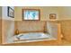 Bathroom showcasing the bathtub under the window and tiled walls at 812 High Point Dr, Breckenridge, CO 80424