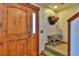 Welcoming entrance with a wooden door, flower pot, and a stool on the stairs at 812 High Point Dr, Breckenridge, CO 80424