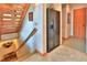 Hallway with stairs, a stainless-steel refrigerator, and neutral tile flooring at 812 High Point Dr, Breckenridge, CO 80424
