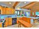 Warm, rustic kitchen with wood beams, cabinets, and tile floors, creating a cozy culinary space at 812 High Point Dr, Breckenridge, CO 80424
