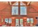 Living area showcasing vaulted ceilings, large windows, and log walls, offering scenic views and natural light at 812 High Point Dr, Breckenridge, CO 80424