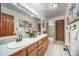 Well-lit bathroom featuring a double sink vanity, a large mirror and a shower at 767 Tenderfoot Dr, Larkspur, CO 80118