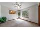 Bright bedroom with natural light from windows and a ceiling fan for comfort at 767 Tenderfoot Dr, Larkspur, CO 80118