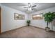 Bright bedroom features neutral carpet, ceiling fan, artwork, and natural light at 767 Tenderfoot Dr, Larkspur, CO 80118