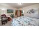This cozy bedroom is filled with light, art, and a comfortable seating area at 767 Tenderfoot Dr, Larkspur, CO 80118