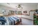Bright bedroom featuring large windows with wooded views and a striking fan and fixtures at 767 Tenderfoot Dr, Larkspur, CO 80118