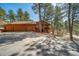 Inviting two-story home with a three-car garage, well-maintained driveway, and natural surroundings at 767 Tenderfoot Dr, Larkspur, CO 80118