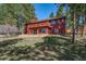Exterior view of the two-story home featuring balcony and well-maintained lawn at 767 Tenderfoot Dr, Larkspur, CO 80118