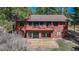 Rear exterior featuring a spacious second-story deck, walk-out basement, and landscaped area at 767 Tenderfoot Dr, Larkspur, CO 80118