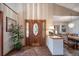 Foyer with a decorative glass front door, tile flooring, and a view into the dining room at 767 Tenderfoot Dr, Larkspur, CO 80118