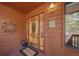 Close-up of the front door with decorative glass, a 'Welcome' mat, and exterior wall decor at 767 Tenderfoot Dr, Larkspur, CO 80118