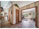 Hallway leading to an office space with ample natural light and tile flooring at 767 Tenderfoot Dr, Larkspur, CO 80118