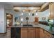 Open concept kitchen offering stainless steel appliances, granite counters, and oak cabinets at 767 Tenderfoot Dr, Larkspur, CO 80118